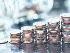 a pile of coins sitting on top on the table