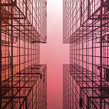 looking up view of a building with glass windows