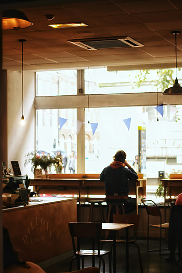 a person sitting at a table in a room with a window