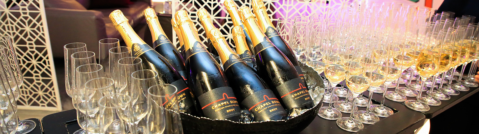 a group of bottles of champagne and glasses on a table