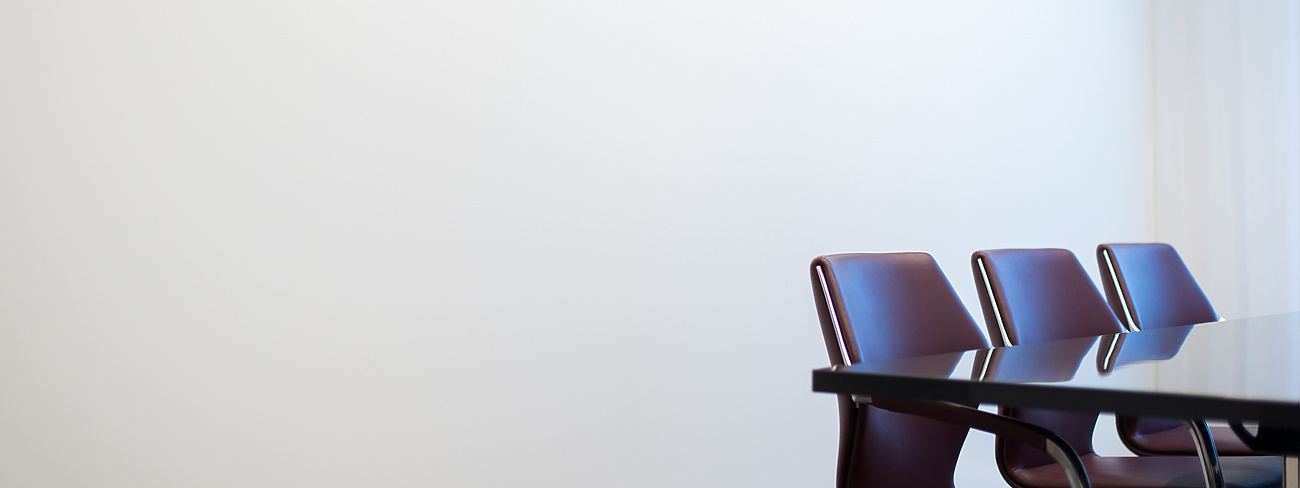 Brown chairs round a meeting table