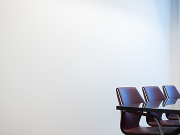 Brown chairs round a meeting table