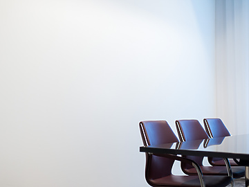 Brown chairs round a meeting table