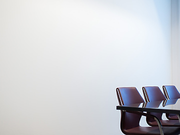 Brown chairs round a meeting table