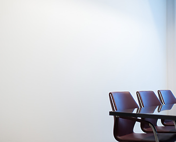 Brown chairs round a meeting table