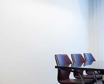 Brown chairs round a meeting table