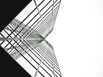 looking up a tall building with windows