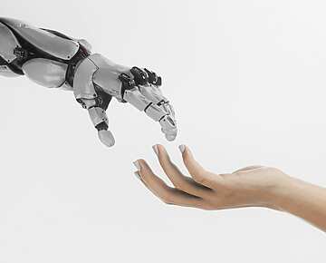 a-hand-reaching-out-towards-a-robot-hand