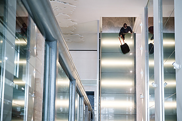 a person with luggage on a staircase