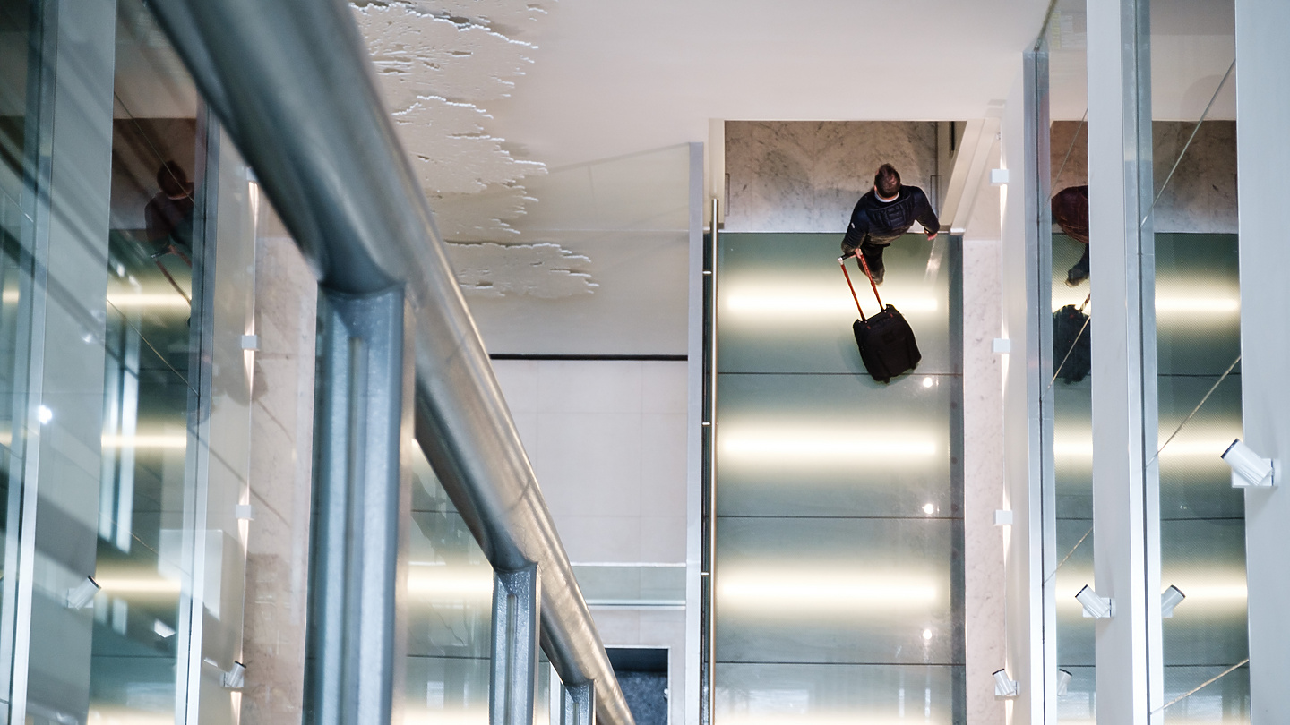 a person with luggage on a staircase