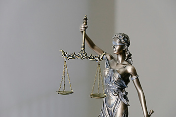 a statue of a person holding scales