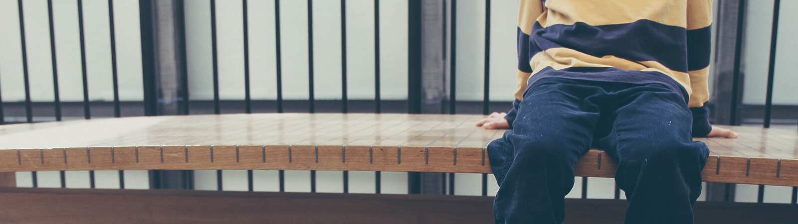 child waiting on bench