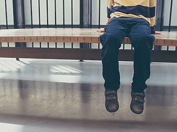 child waiting on bench