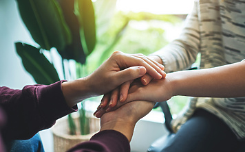 a close-up of hands holding each other